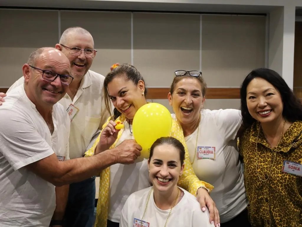 A diverse group of adults beaming at a Break Free Experience event